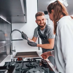 young-professional-plumber-in-grey-uniform-shows-results-of-work-for-housewife-on-the-kitchen.jpg young-professional-plumber-in-grey-uniform-shows-results-of-work-for-housewife-on-the-kitchen.jpg
